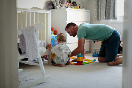 documentary family shoot - paul plays with Arlo's train set