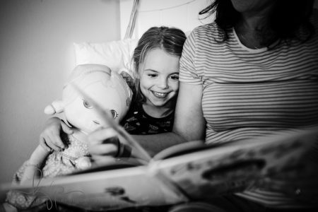 documentary family shoot - Olivia reads Audrey a bedtime story