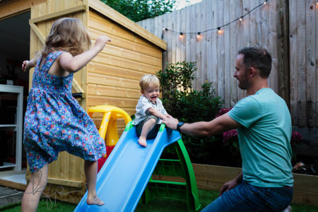 documentary family shoot - arlo and audrey play on the slide